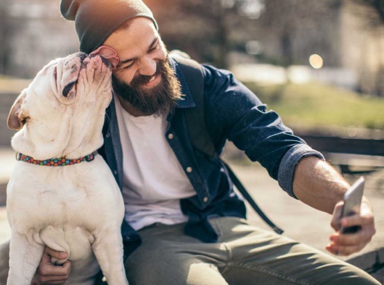 a man taking a selfie with his dog