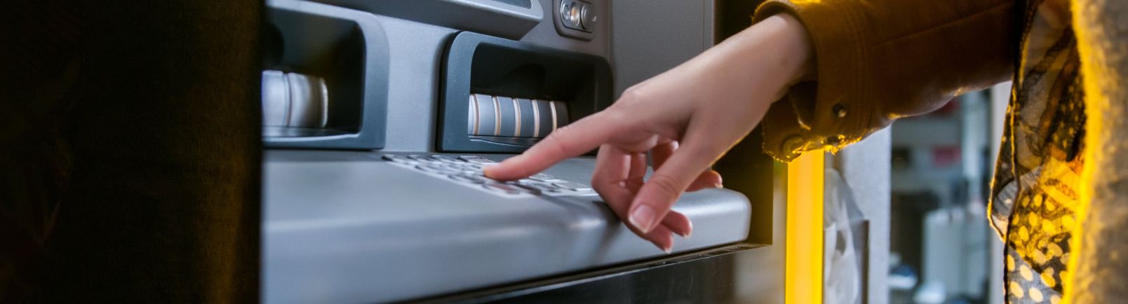 a lady using an ATM machine