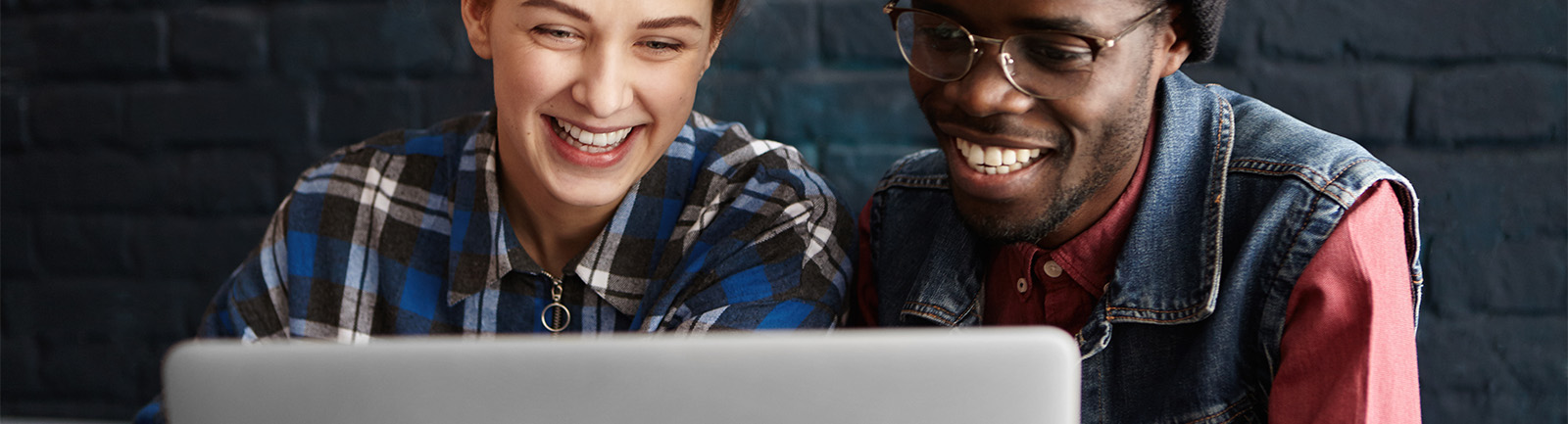 two people viewing their laptop