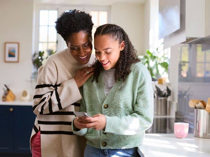 Mother and daughter looking at a cellphone