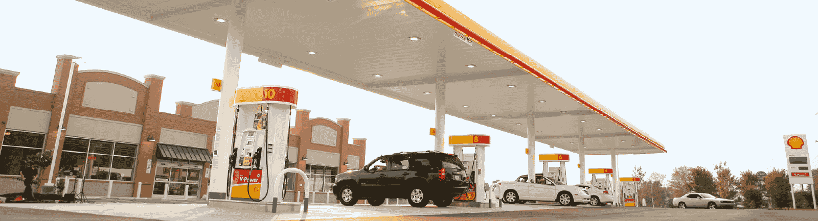 Shell gas station with cars parked at gas pumps